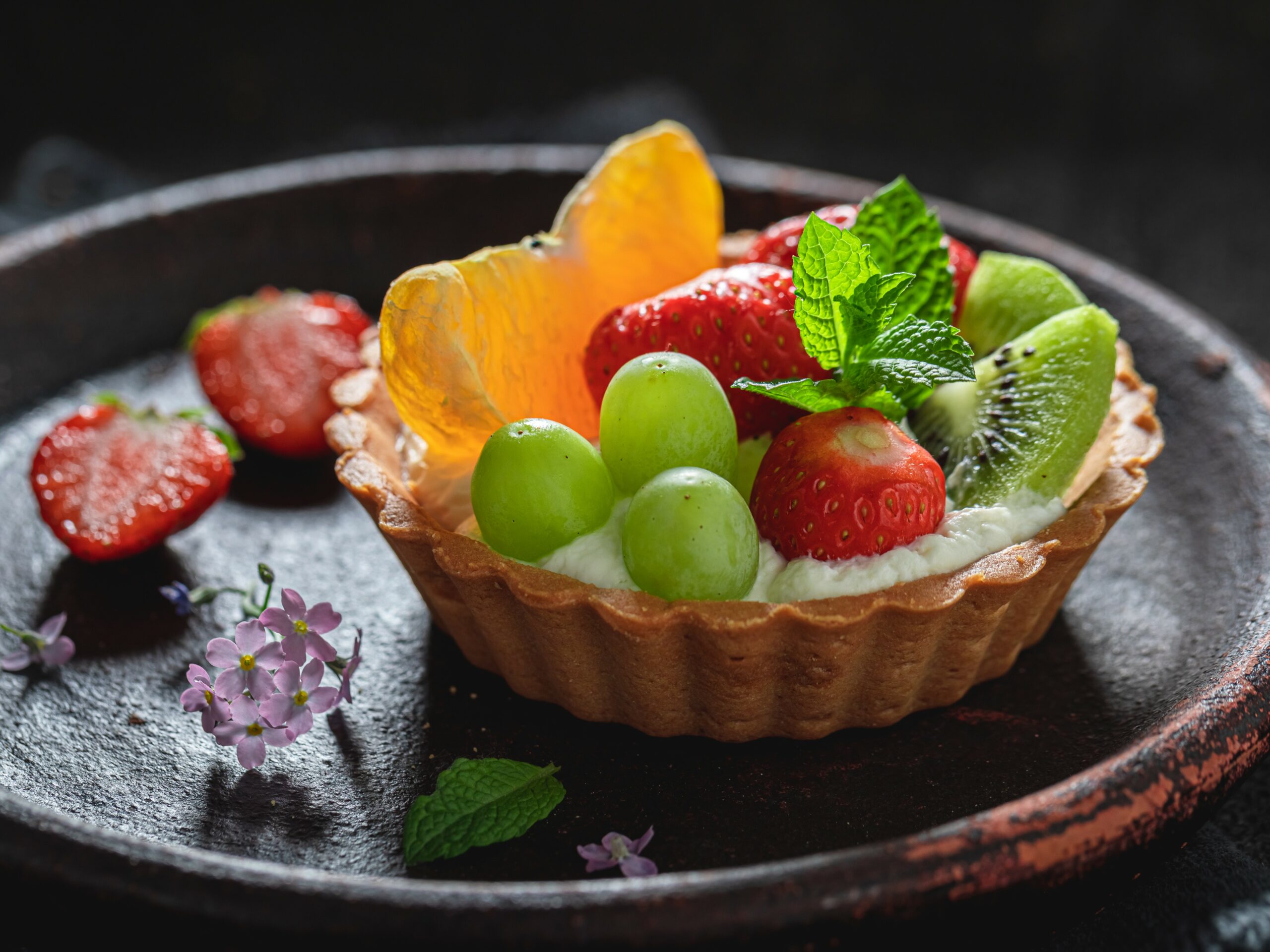 Tasty mini tart with whipped cream and fresh fruits Tasty mini tart with whipped cream and fresh fruits